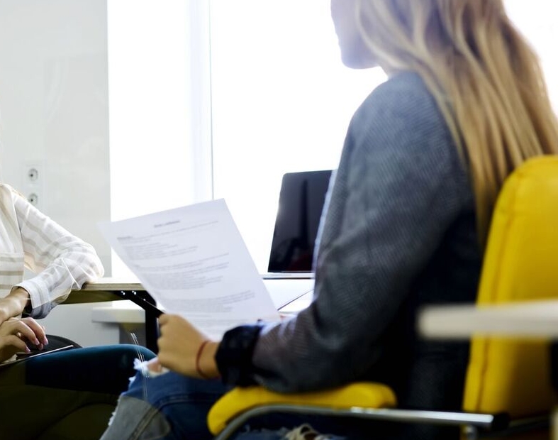 two individuals in a work setting discussing outplacement and career transitions support